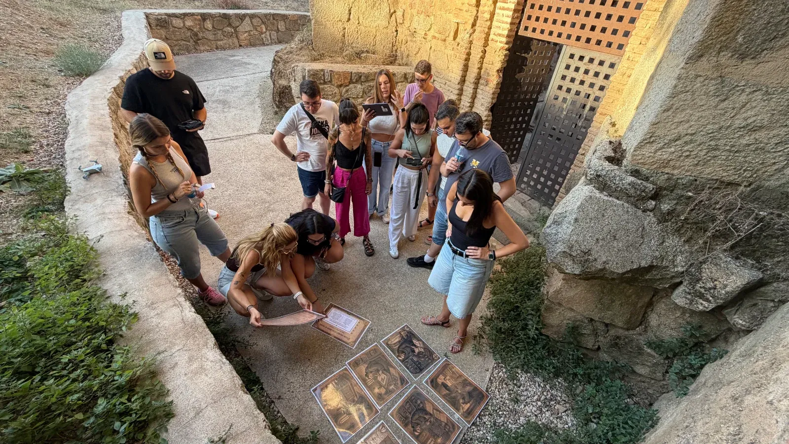 Equipo ordenando láminas en el suelo dentro del recinto del monasterio